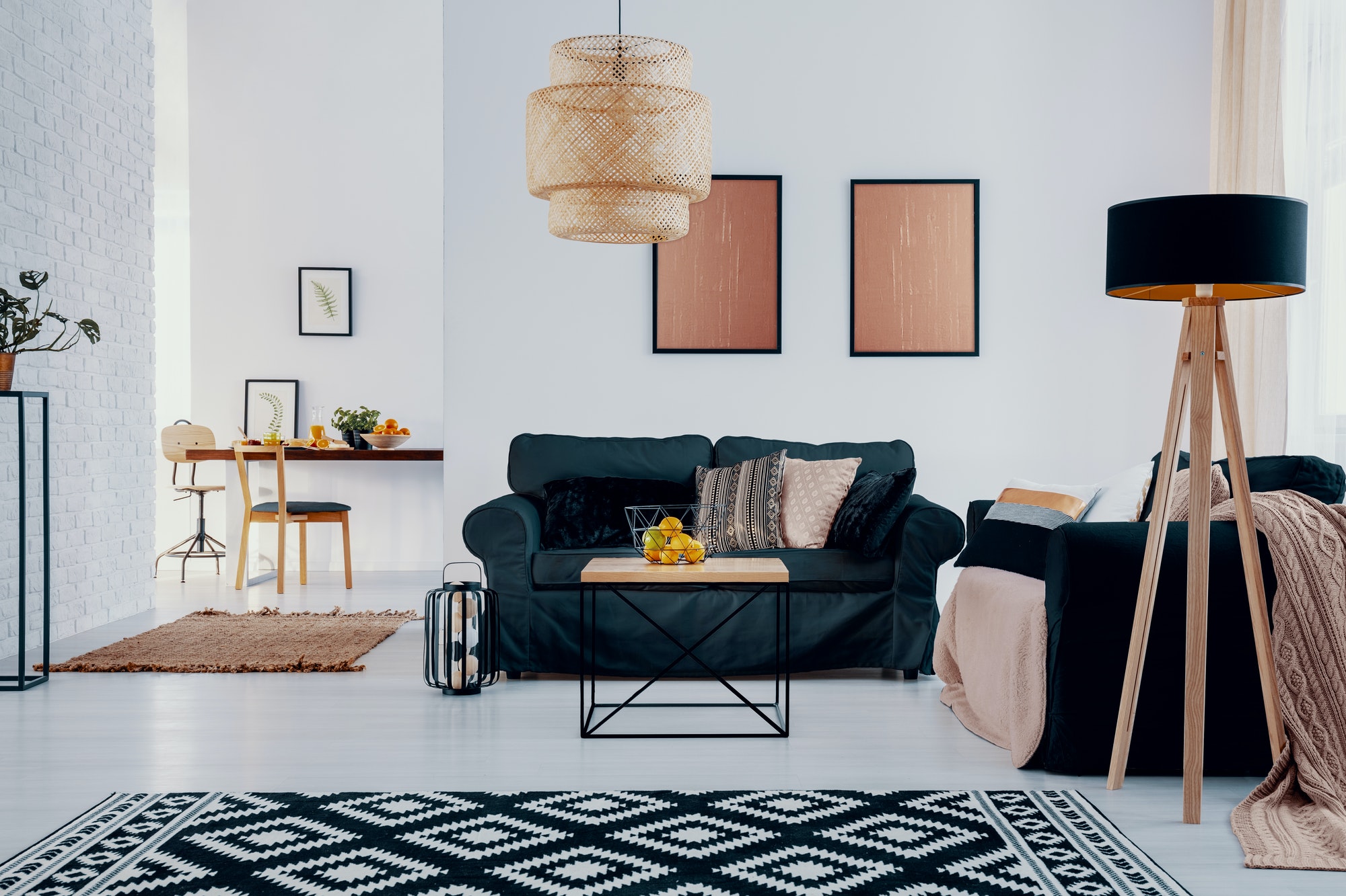 pink posters above green sofa in bright apartment interior with.jpg